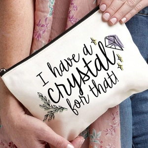 Close-up of canvas makeup bag with I have a crystal for that print and black zipper