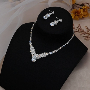 Detail of silver teardrop necklace and earrings set with sparkling zircon stones