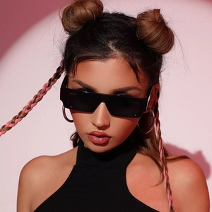 Chic black small square sunglasses and silver hoop earrings on a fashion model