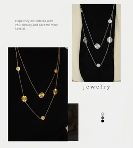 Detail of layered titanium steel sweater necklace with textured round pendants in gold and silver