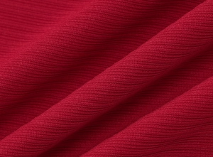 Gros plan de la texture du tricot côtelé rouge avec détails de dentelle de qualité
