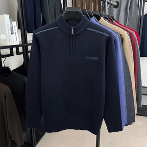 Close-up of assorted colors of men's half-zip knit sweaters in a neat row display