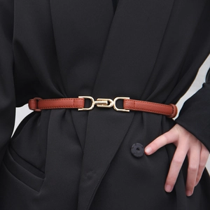 Brown leather waist belt for women featuring a stylish gold D-ring buckle on a black blazer