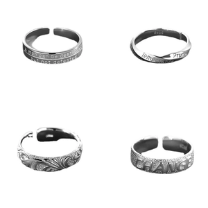 Set of four vintage copper alloy silver rings with diverse textures and engraved motifs