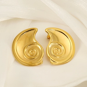 Vue détaillée des boucles d'oreilles spirales dorées avec texture métal poli chic