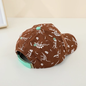 Detail of kids baseball cap with dinosaur skeleton prints and velcro strap adjustment
