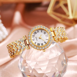 Gold rhinestone quartz watch detail, crystal stand display, elegant womens wrist watch.