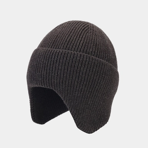 Close-up of thick ribbed knit texture on dark brown trapper beanie with ear protection