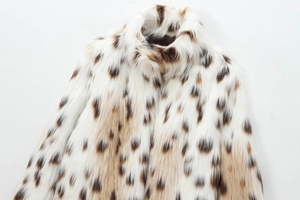 Close-up of fluffy faux fur texture with beige and brown leopard print pattern