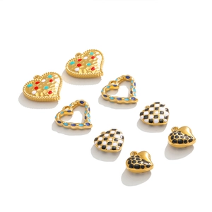 Detailed view of colorful heart charms with checkered and polka dot patterns for DIY jewelry