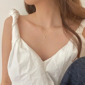 Minimalist 925 sterling silver gold necklace with a tiny teardrop pendant worn on neck