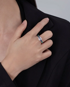 Macro detail of Asscher cut main stone and colorful side stones on silver ring