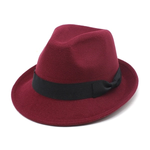 Detail of burgundy wool fedora hat featuring black grosgrain ribbon and classic bow tie