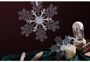Macro view of transparent acrylic snowflakes on a festive red background with ice texture