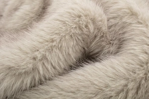 Macro shot of soft faux fur texture in light grey with high-end fluffy fiber details