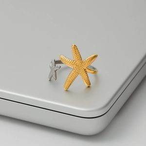 Detail of starfish rings with gold and silver finishes and textured surface details