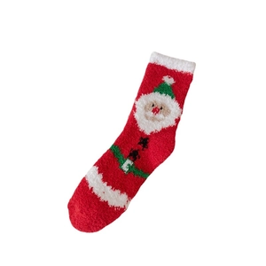 Christmas coral fleece socks with 3D Santa Claus pattern on a clean white background