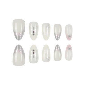 Handmade almond press-on nails set with silver bows, stars and rhinestones on milky white