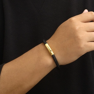 Men's black braided leather bracelet with golden stainless steel buckle on wrist