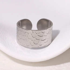 Macro shot of silver adjustable wide ring with unique honeycomb geometric metal texture