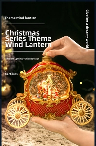 Detailed close-up of a vintage red Christmas carriage music box with gold embossed decor