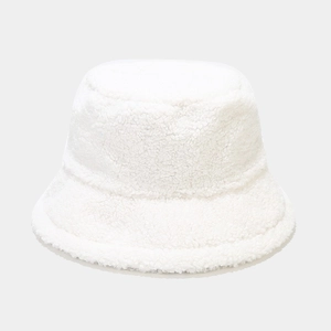 Detailed view of the soft white faux shearling texture on a warm winter bucket hat