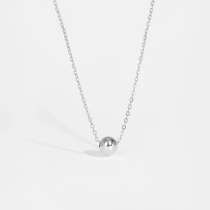 Close-up of minimalist 925 sterling silver sphere pendant with polished metallic finish