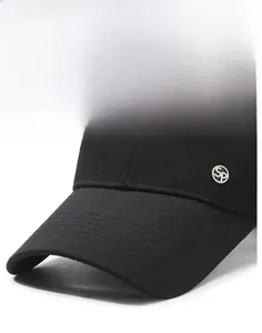 Detail of black baseball cap brim with metallic SP logo and twill fabric texture