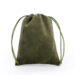 Close-up of olive green velvet drawstring pouch showing soft suede texture on white background