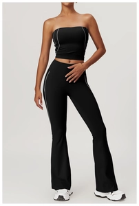 Detail view of black yoga set with high waist flare pants and white contrast stripes