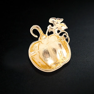 Back view of gold-plated Halloween pumpkin brooch with metal pin and secure buckle closure