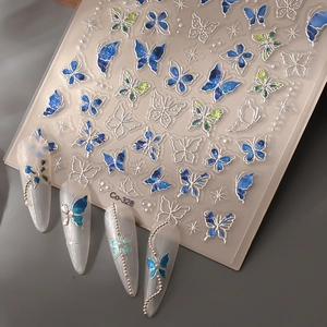 Macro view of 3D ice-transparent butterfly nail stickers with silver embossed butterfly wings