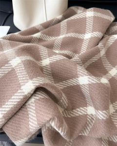Close-up of soft plaid scarf showing thick coffee and beige twill weave texture