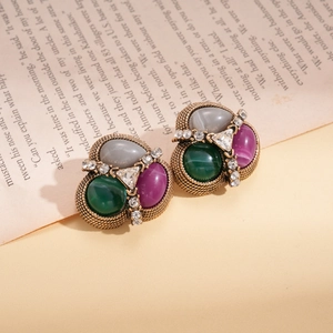 Macro shot of vintage style earrings with multicolor gemstones and crystal triangles