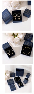 Blue jewelry gift set featuring gold heart earrings and beaded bracelet in a box