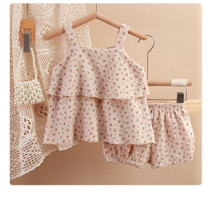 Detailed view of floral cotton gauze baby girl set with ruffled camisole and shorts