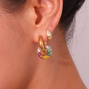 Close-up of gold-plated hoop earrings with micro-set colorful zircon pendant on ear