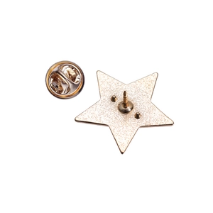 Detail of gold star alloy brooch back with secure needle and butterfly clutch fastener