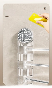 Detail view of transparent acrylic bathroom towel rack with silver swivel metal bars