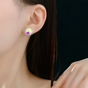 Macro close-up of a sparkling square iridescent crystal earring on model's ear