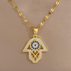 Gold Hamsa Hand necklace with blue eye pendant and sparkling rhinestones for women