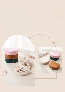 Detail view of semi-circular portable jewelry box with multi-compartment storage zones