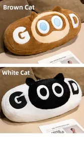 Detail of soft plush long cat pillows in brown and white with creative embroidered face