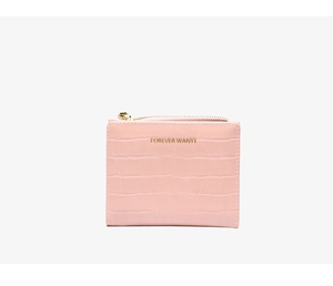 Detail of pink slim wallet featuring faux crocodile texture and gold zipper closure