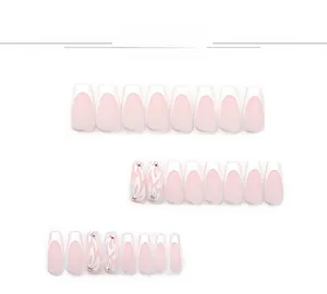 French ombre press-on nails with white floral patterns and small crystal rhinestone accents