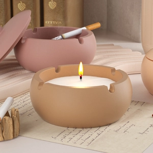 Gros plan de pots de rangement en silicone mat pour bougies aux tons jaune et rose poudré