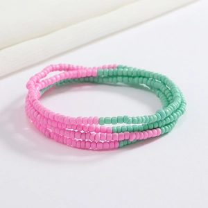 Detail view of pink and green beaded belly chain with elastic multi-layer design