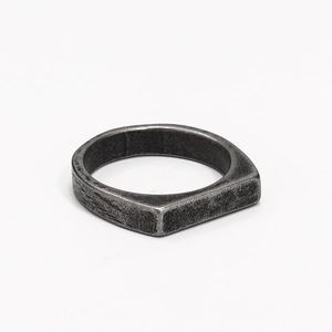 Close-up of minimalist industrial style ring with a vintage silver finish and oxidized texture