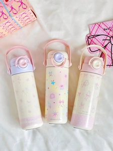 Detailed trio of cute cartoon stainless steel water bottles on a white fabric backdrop