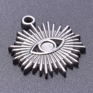 Macro shot of silver evil eye pendant with radiant rays and polished metallic finish